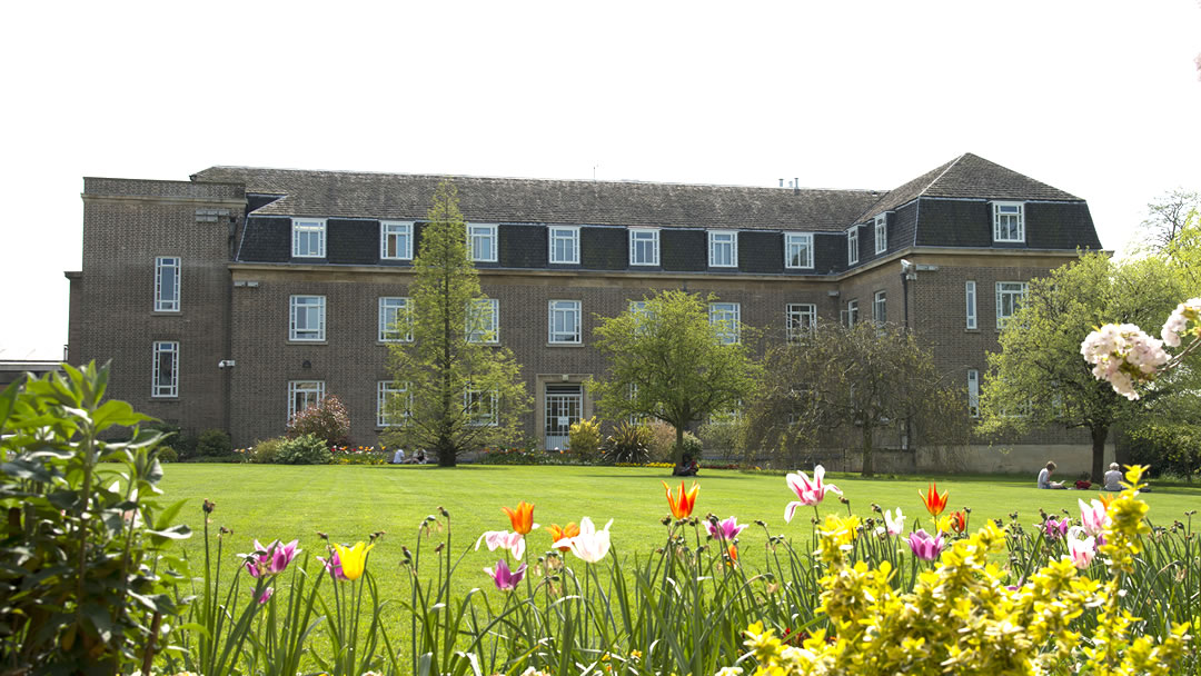 Outside view of the Astley Clarke Building and lawn