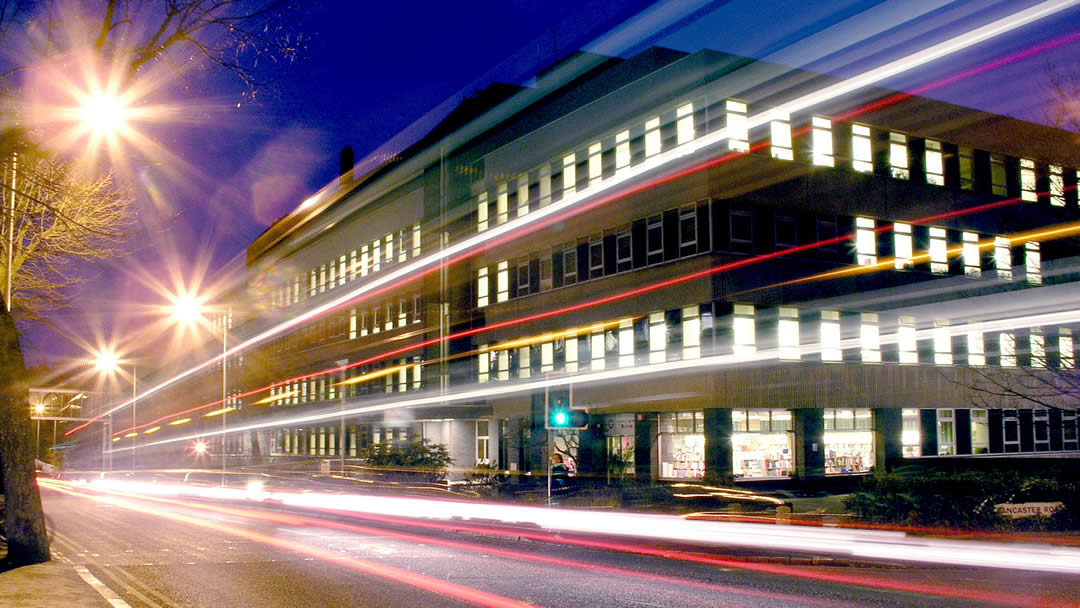 Outside view of the Maurice Shock Building at night time